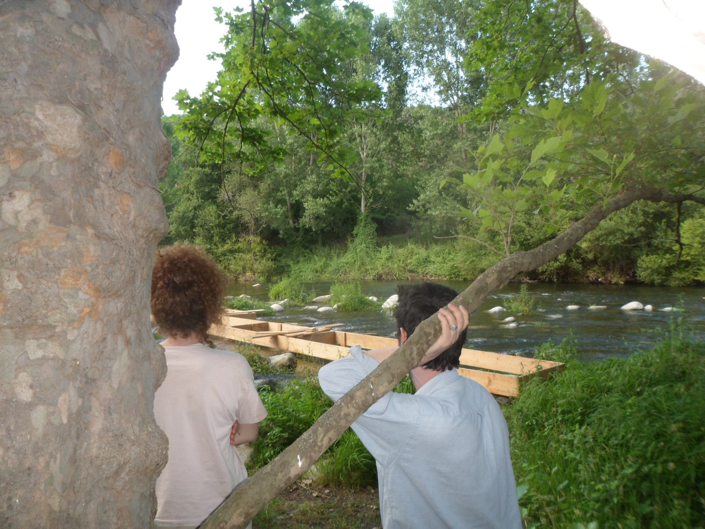 Carrying the planks for the jetty along the river, among the trees.